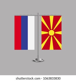 Table stand with flags of Russia and Macedonia.Two flag. Flag pole. Symbolizing the cooperation between the two countries.Table flags