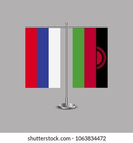 Table stand with flags of Russia and Malawi.Two flag. Flag pole. Symbolizing the cooperation between the two countries.Table flags