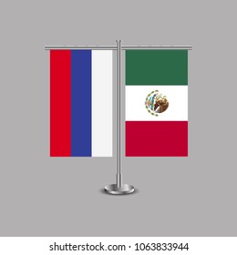 Table stand with flags of Russia and Mexico.Two flag. Flag pole. Symbolizing the cooperation between the two countries.Table flags