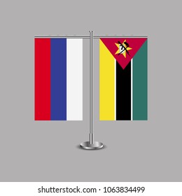 Table stand with flags of Russia and Mozambique.Two flag. Flag pole. Symbolizing the cooperation between the two countries.Table flags