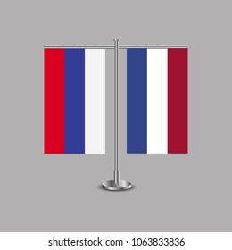 Table stand with flags of Russia and Netherlands.Two flag. Flag pole. Symbolizing the cooperation between the two countries.Table flags