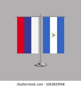 Table stand with flags of Russia and Nicaragua.Two flag. Flag pole. Symbolizing the cooperation between the two countries.Table flags