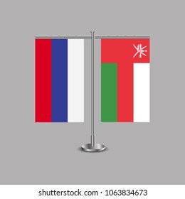 Table stand with flags of Russia and Oman.Two flag. Flag pole. Symbolizing the cooperation between the two countries.Table flags