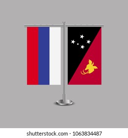 Table stand with flags of Russia and Papua New Guinea.Two flag. Flag pole. Symbolizing the cooperation between the two countries.Table flags