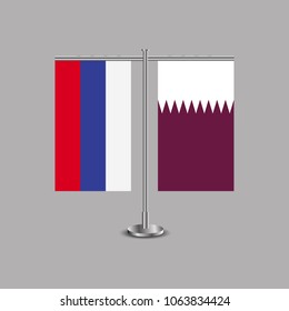 Table stand with flags of Russia and Qatar.Two flag. Flag pole. Symbolizing the cooperation between the two countries.Table flags