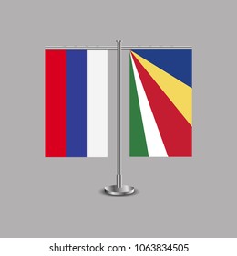 Table stand with flags of Russia and Seychelles.Two flag. Flag pole. Symbolizing the cooperation between the two countries.Table flags