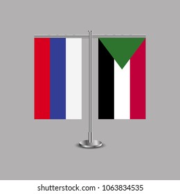 Table stand with flags of Russia and Sudan.Two flag. Flag pole. Symbolizing the cooperation between the two countries.Table flags