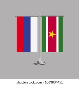 Table stand with flags of Russia and Suriname.Two flag. Flag pole. Symbolizing the cooperation between the two countries.Table flags