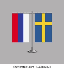 Table stand with flags of Russia and Sweden.Two flag. Flag pole. Symbolizing the cooperation between the two countries.Table flags