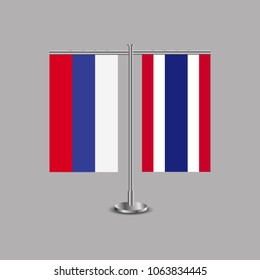Table stand with flags of Russia and Thailand.Two flag. Flag pole. Symbolizing the cooperation between the two countries.Table flags