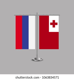 Table stand with flags of Russia and Tonga.Two flag. Flag pole. Symbolizing the cooperation between the two countries.Table flags