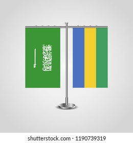 Table stand with flags of Saudi Arabia and Gabon.Two flag. Flag pole. Symbolizing the cooperation between the two countries. Table flags