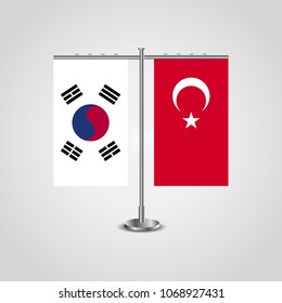 Table stand with flags of South Korea and Turkey.Two flag. Flag pole. Symbolizing the cooperation between the two countries. Table flags