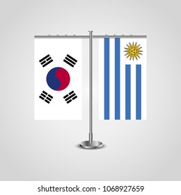 Table stand with flags of South Korea and Uruguay.Two flag. Flag pole. Symbolizing the cooperation between the two countries. Table flags