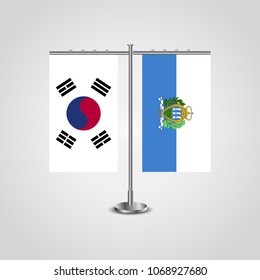 Table stand with flags of South Korea and San marino.Two flag. Flag pole. Symbolizing the cooperation between the two countries. Table flags