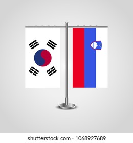 Table stand with flags of South Korea and Slovenia.Two flag. Flag pole. Symbolizing the cooperation between the two countries. Table flags