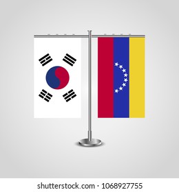 Table stand with flags of South Korea and Venezuela.Two flag. Flag pole. Symbolizing the cooperation between the two countries. Table flags