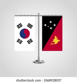 Table stand with flags of South Korea and Papua New Guinea.Two flag. Flag pole. Symbolizing the cooperation between the two countries. Table flags