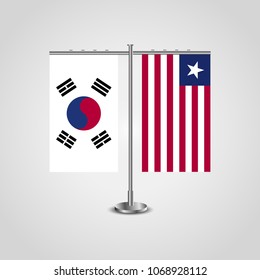 Table stand with flags of South Korea and Liberia.Two flag. Flag pole. Symbolizing the cooperation between the two countries. Table flags