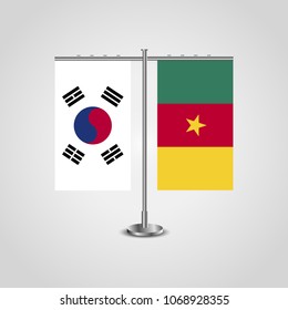 Table stand with flags of South Korea and Cameroon.Two flag. Flag pole. Symbolizing the cooperation between the two countries. Table flags