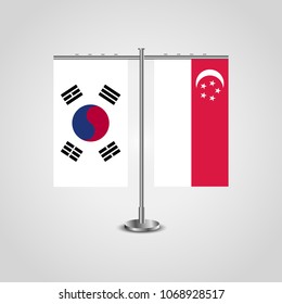 Table stand with flags of South Korea and Singapore.Two flag. Flag pole. Symbolizing the cooperation between the two countries. Table flags