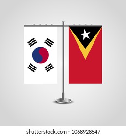 Table stand with flags of South Korea and East Timor.Two flag. Flag pole. Symbolizing the cooperation between the two countries. Table flags