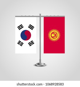 Table stand with flags of South Korea and Kyrgyzstan.Two flag. Flag pole. Symbolizing the cooperation between the two countries. Table flags