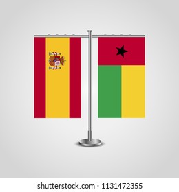 Table stand with flags of Spain and Guinea-Bissau.Two flag. Flag pole. Symbolizing the cooperation between the two countries. Table flags
