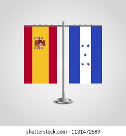Table stand with flags of Spain and Honduras.Two flag. Flag pole. Symbolizing the cooperation between the two countries. Table flags

