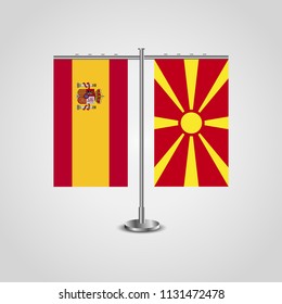 Table stand with flags of Spain and Macedonia.Two flag. Flag pole. Symbolizing the cooperation between the two countries. Table flags
