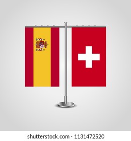 Table stand with flags of Spain and Switzerland.Two flag. Flag pole. Symbolizing the cooperation between the two countries. Table flags
