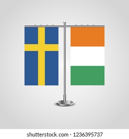 Table stand with flags of Sweden and Côte d'Ivoire.Two flag. Flag pole. Symbolizing the cooperation between the two countries. Table flags