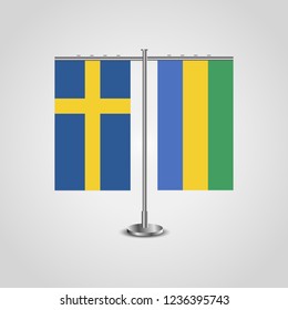 Table stand with flags of Sweden and Gabon.Two flag. Flag pole. Symbolizing the cooperation between the two countries. Table flags