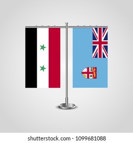 Table stand with flags of Syria and Fiji.Two flag. Flag pole. Symbolizing the cooperation between the two countries. Table flags
