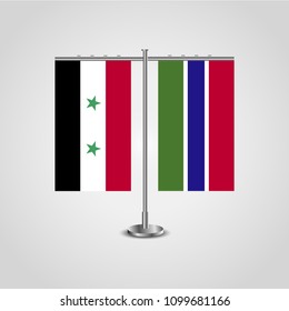 Table stand with flags of Syria and Gambia.Two flag. Flag pole. Symbolizing the cooperation between the two countries. Table flags