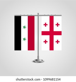 Table stand with flags of Syria and Georgia.Two flag. Flag pole. Symbolizing the cooperation between the two countries. Table flags