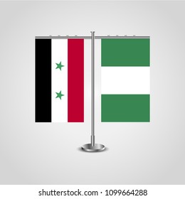 Table stand with flags of Syria and Nigeria.Two flag. Flag pole. Symbolizing the cooperation between the two countries. Table flags