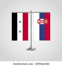 Table stand with flags of Syria and Serbia.Two flag. Flag pole. Symbolizing the cooperation between the two countries. Table flags