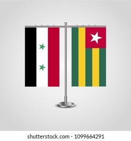 Table stand with flags of Syria and Togo.Two flag. Flag pole. Symbolizing the cooperation between the two countries. Table flags