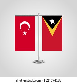 Table stand with flags of Turkey and East Timor.Two flag. Flag pole. Symbolizing the cooperation between the two countries. Table flags