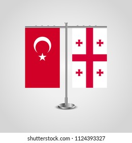 Table stand with flags of Turkey and Georgia.Two flag. Flag pole. Symbolizing the cooperation between the two countries. Table flags