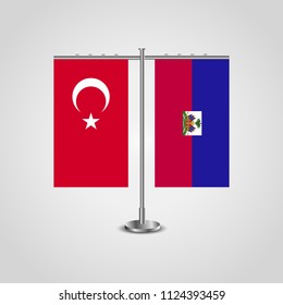 Table stand with flags of Turkey and Haiti.Two flag. Flag pole. Symbolizing the cooperation between the two countries. Table flags