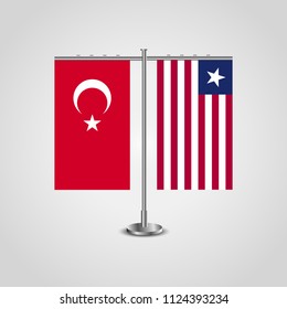 Table stand with flags of Turkey and Liberia.Two flag. Flag pole. Symbolizing the cooperation between the two countries. Table flags