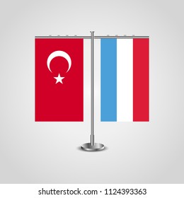 Table stand with flags of Turkey and Luxembourg.Two flag. Flag pole. Symbolizing the cooperation between the two countries. Table flags