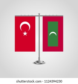 Table stand with flags of Turkey and Maldives.Two flag. Flag pole. Symbolizing the cooperation between the two countries. Table flags