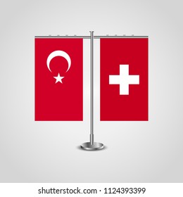 Table stand with flags of Turkey and Switzerland.Two flag. Flag pole. Symbolizing the cooperation between the two countries. Table flags