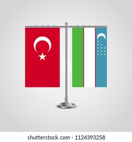 Table stand with flags of Turkey and Uzbekistan.Two flag. Flag pole. Symbolizing the cooperation between the two countries. Table flags
