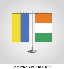 Table stand with flags of Ukraine and Côte d'Ivoire.Two flag. Flag pole. Symbolizing the cooperation between the two countries. Table flags