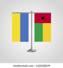 Table stand with flags of Ukraine and Guinea-Bissau.Two flag. Flag pole. Symbolizing the cooperation between the two countries. Table flags