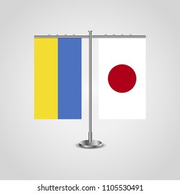 Table stand with flags of Ukraine and Japan.Two flag. Flag pole. Symbolizing the cooperation between the two countries. Table flags